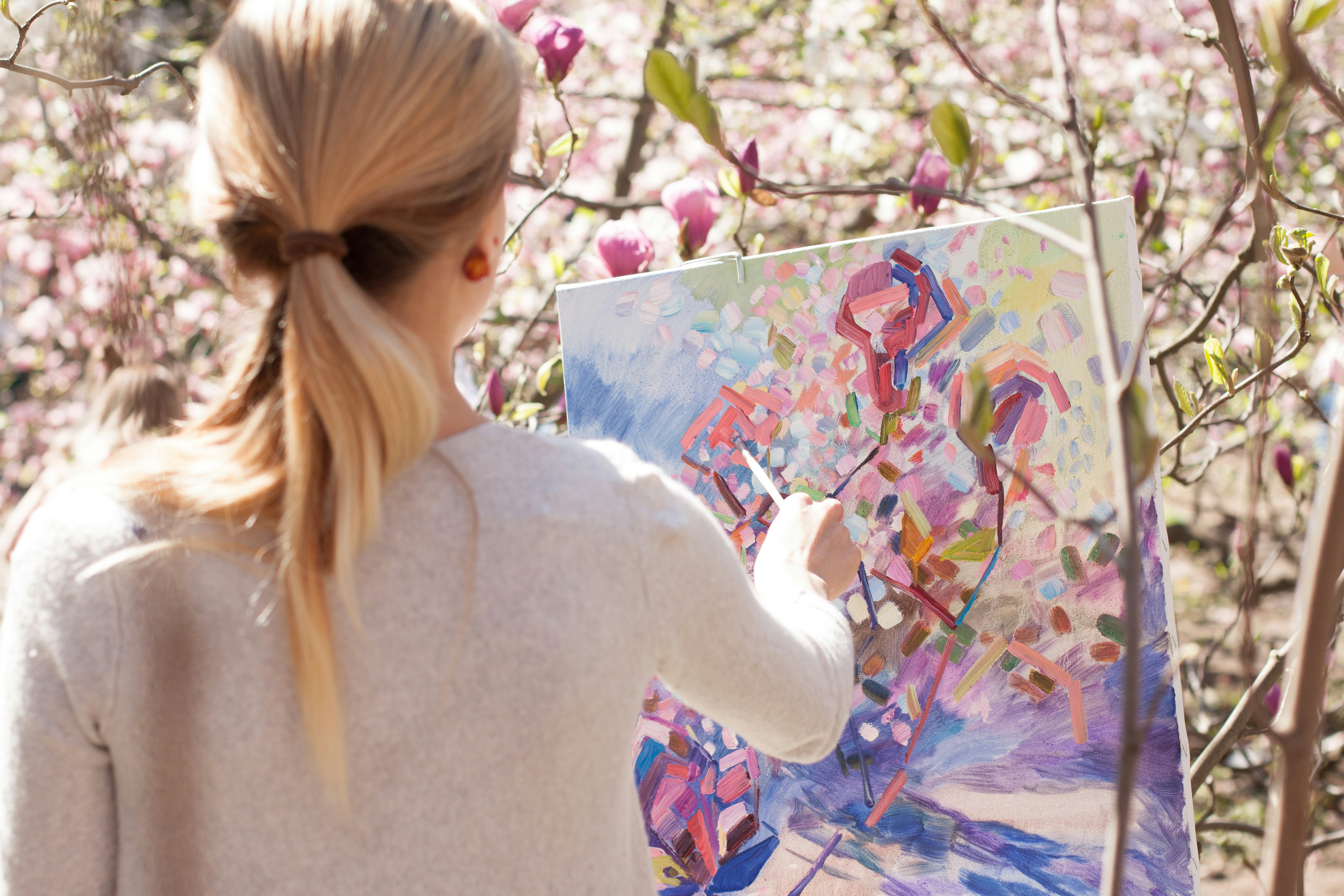 Artist painting a vibrant colorful canvas outdoors in Napa
