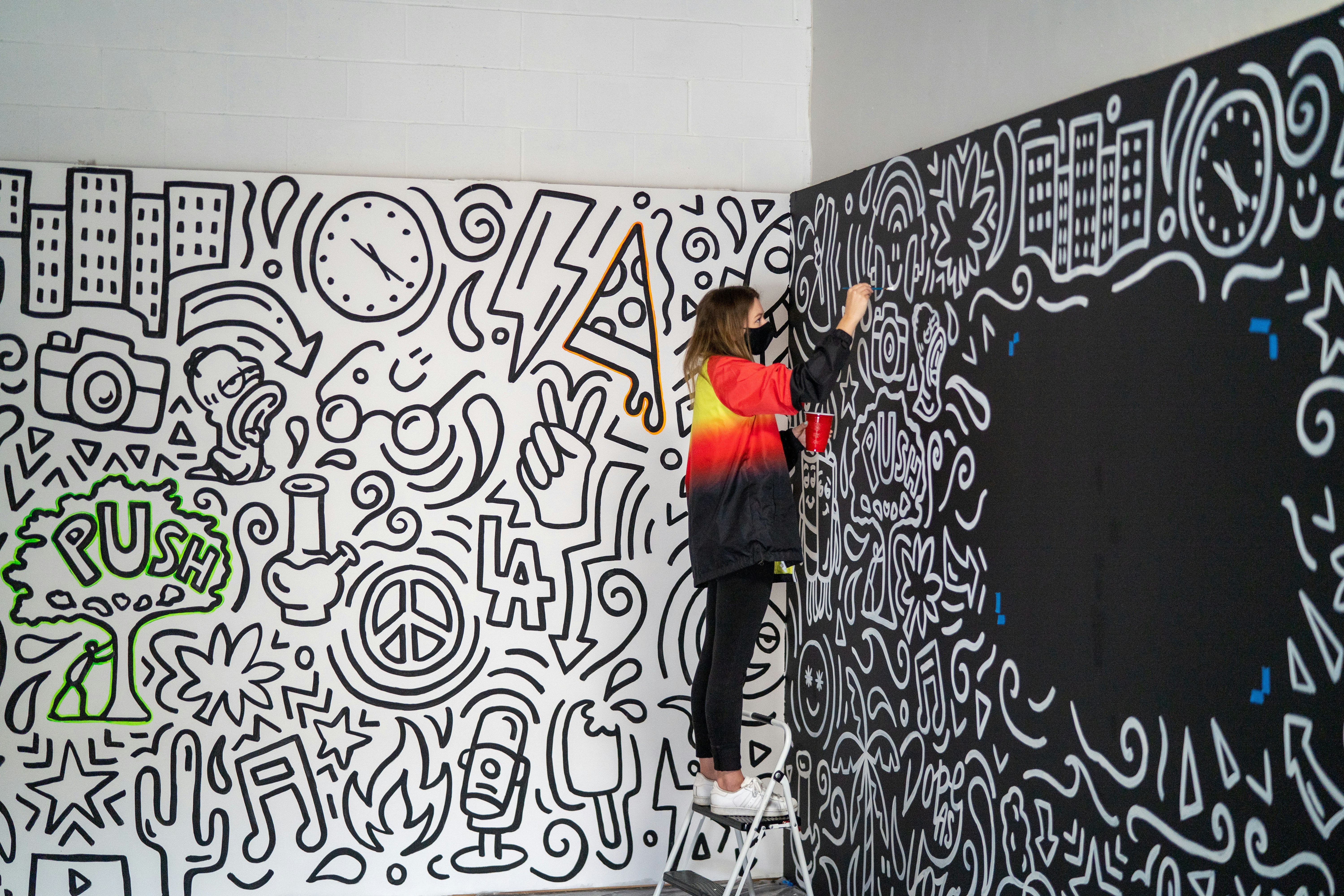 Artist creating a large-scale mural — commercial art in Napa